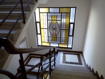 Zábradlí i schodišťové stupně prošly repasí, na mezipodestách jsou repliky původních vitrážových oken