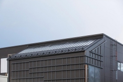 Část budovy s fasádou ze samopatinující oceli Cor-Ten. Šikmá střecha je z krytiny Ruukki Classic s plně integrovaným solárním systémem pro ohřev vody (Ruukki Classic Solar).